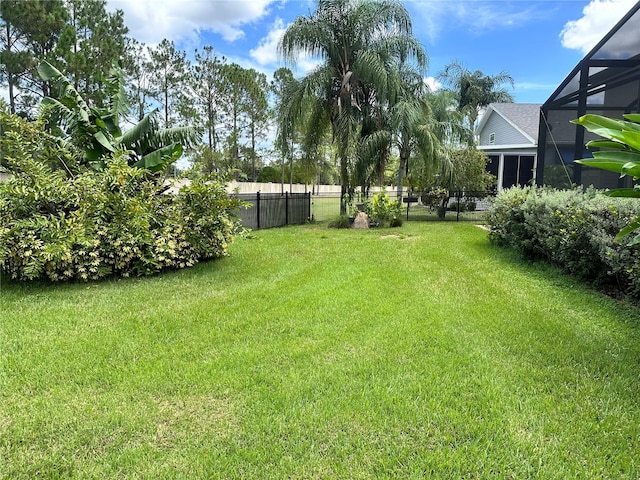 view of yard with glass enclosure