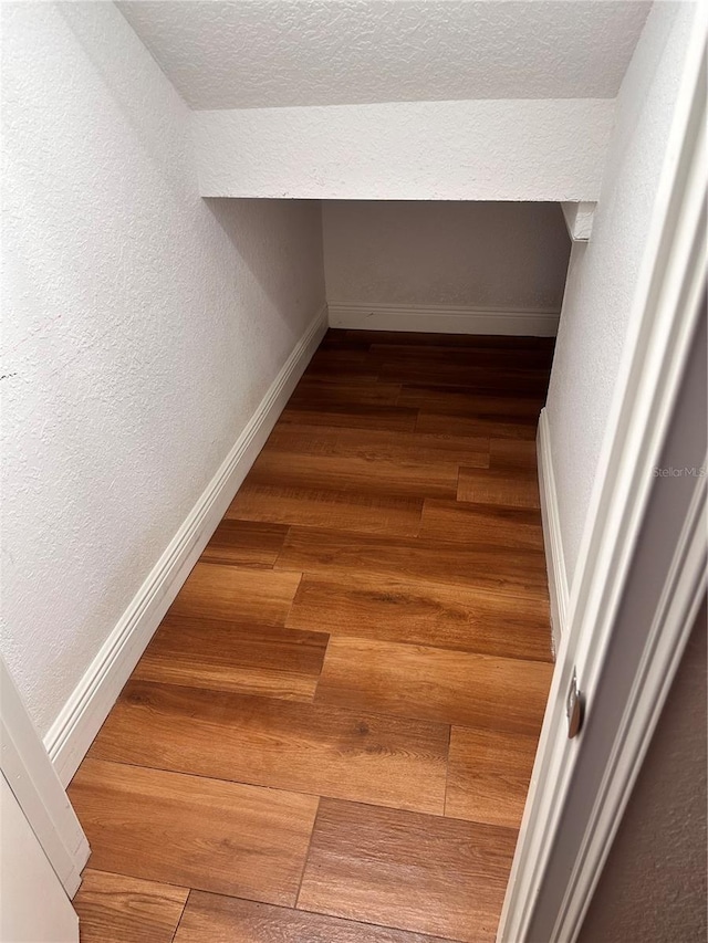 interior space featuring hardwood / wood-style flooring and a textured ceiling