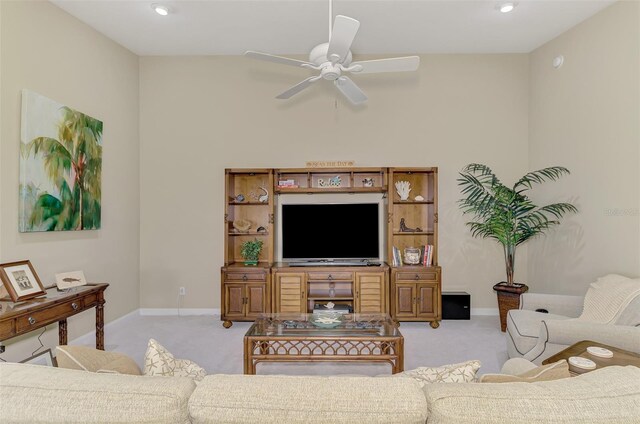 carpeted living room with ceiling fan