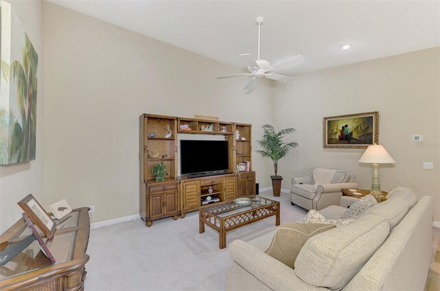 carpeted living room featuring ceiling fan