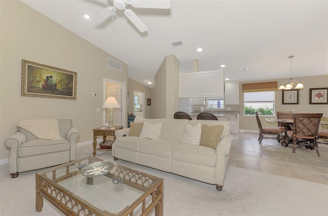 living room with lofted ceiling, visible vents, light tile patterned flooring, and recessed lighting