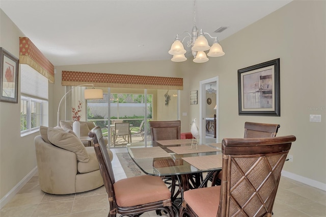 dining room with vaulted ceiling, light tile patterned floors, and a chandelier