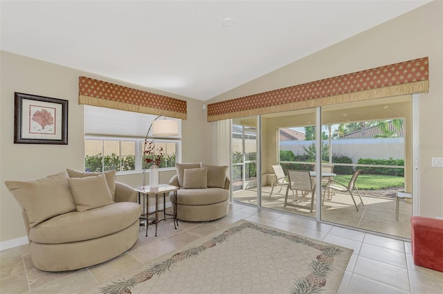 tiled living room featuring vaulted ceiling and a wealth of natural light