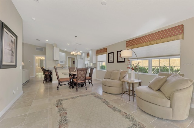 living room featuring a chandelier and light tile patterned floors