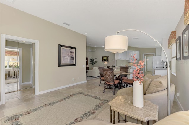 living area with recessed lighting, visible vents, and baseboards