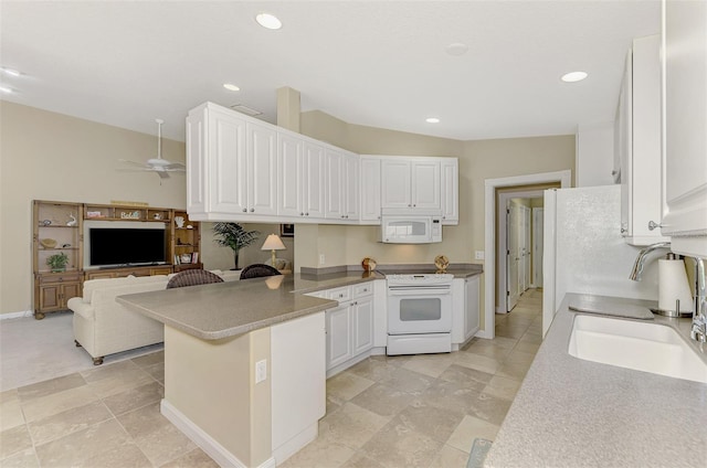 kitchen featuring recessed lighting, a peninsula, white appliances, white cabinetry, and open floor plan