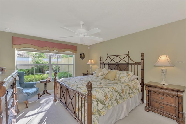 bedroom featuring a ceiling fan and light colored carpet