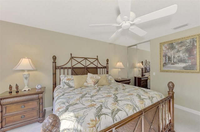 bedroom with light carpet, baseboards, visible vents, ceiling fan, and a closet