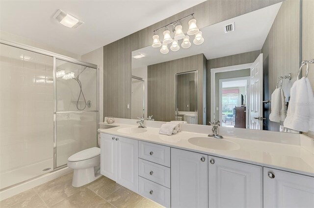 bathroom featuring an enclosed shower, toilet, and vanity