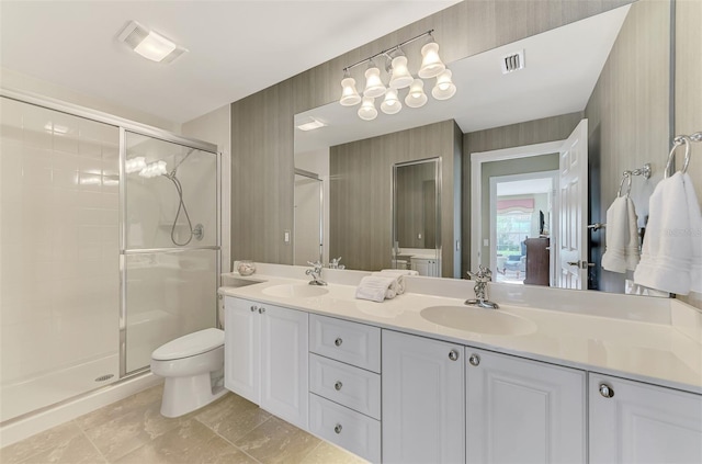 full bath with double vanity, a shower stall, visible vents, and a sink