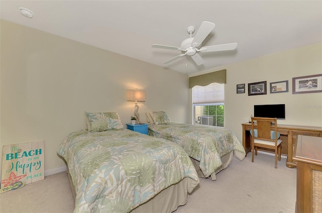 bedroom with baseboards, a ceiling fan, and light colored carpet