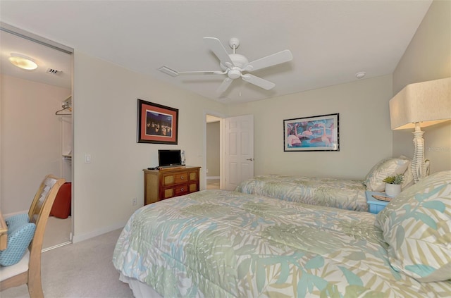 carpeted bedroom featuring ceiling fan and a closet