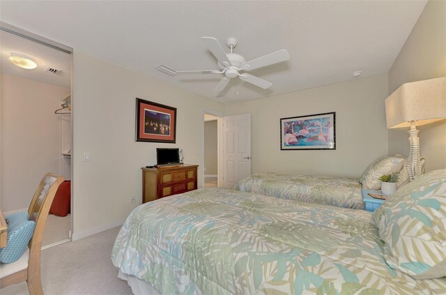 bedroom featuring baseboards, visible vents, a ceiling fan, and light colored carpet