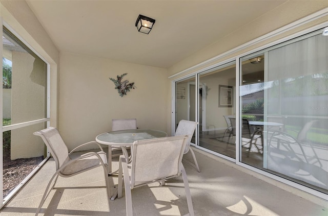 balcony featuring outdoor dining area and a patio