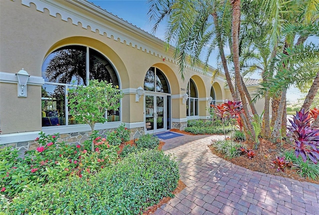 doorway to property with french doors and stucco siding