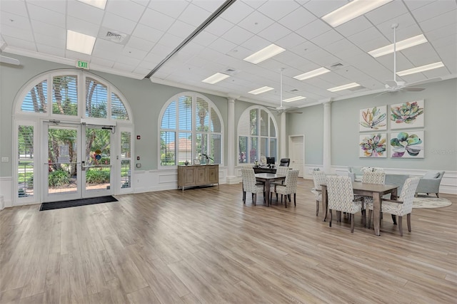 unfurnished dining area featuring french doors, a healthy amount of sunlight, ceiling fan, and light hardwood / wood-style floors