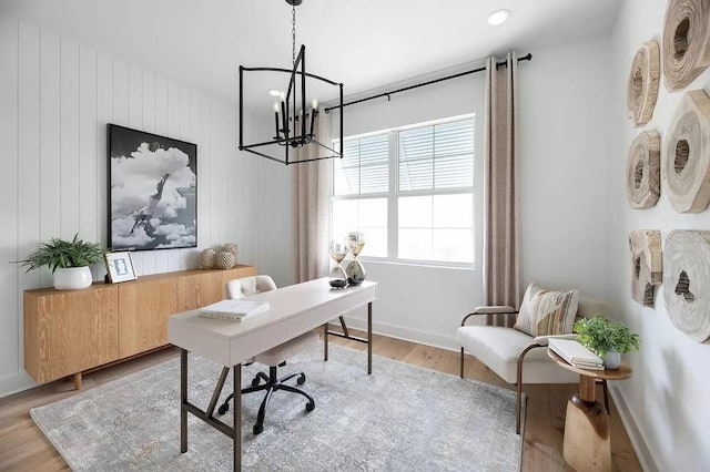 office featuring light wood-type flooring and a notable chandelier