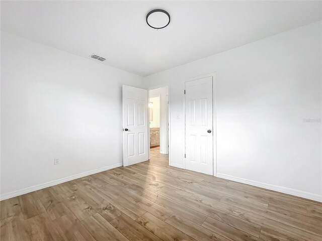 unfurnished bedroom featuring light wood-type flooring