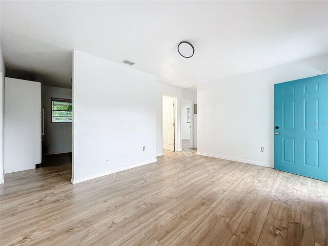 empty room with light hardwood / wood-style floors