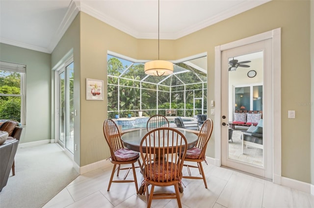 carpeted dining room featuring ceiling fan and ornamental molding