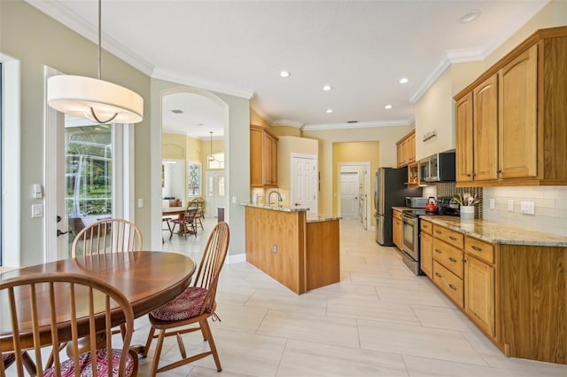 kitchen with appliances with stainless steel finishes, light stone countertops, crown molding, and backsplash