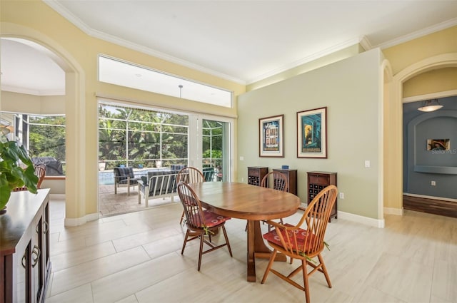 dining room with light tile patterned flooring and crown molding