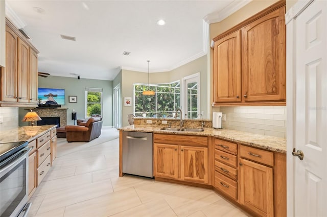 kitchen with decorative backsplash, appliances with stainless steel finishes, light stone countertops, light tile patterned floors, and sink