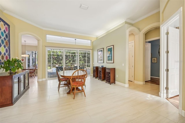 dining room with crown molding and light tile patterned floors