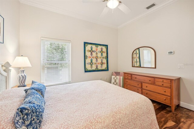 bedroom with ceiling fan, dark hardwood / wood-style floors, and ornamental molding