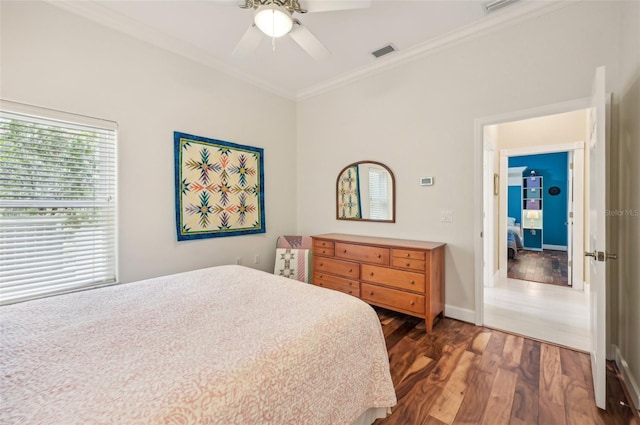 bedroom with ceiling fan, crown molding, and dark wood-type flooring