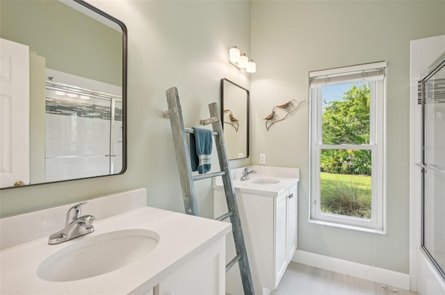 bathroom with bath / shower combo with glass door, vanity, and tile patterned floors