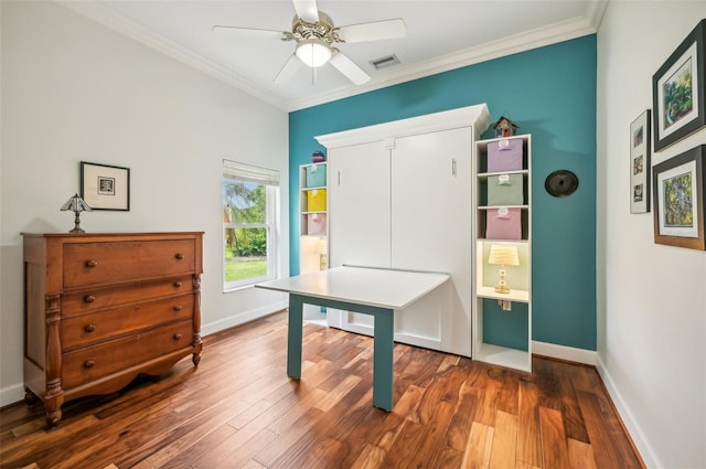 office area featuring ceiling fan, ornamental molding, and hardwood / wood-style flooring