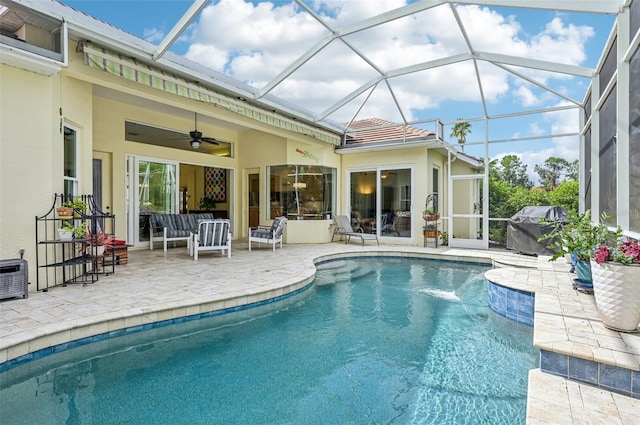 view of pool featuring ceiling fan, a lanai, a patio, pool water feature, and area for grilling