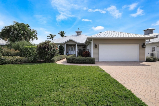 ranch-style house featuring a garage and a front yard