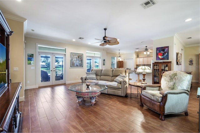 living room featuring ceiling fan, dark hardwood / wood-style floors, ornamental molding, and french doors