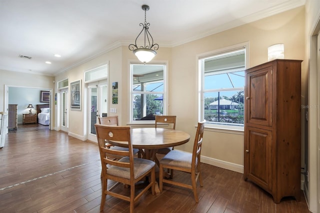 dining room with dark hardwood / wood-style floors and ornamental molding