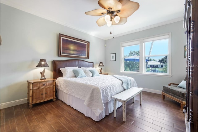 bedroom with crown molding, ceiling fan, and dark hardwood / wood-style floors