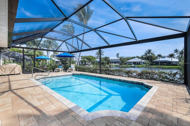 view of swimming pool featuring a lanai, a patio, and a water view