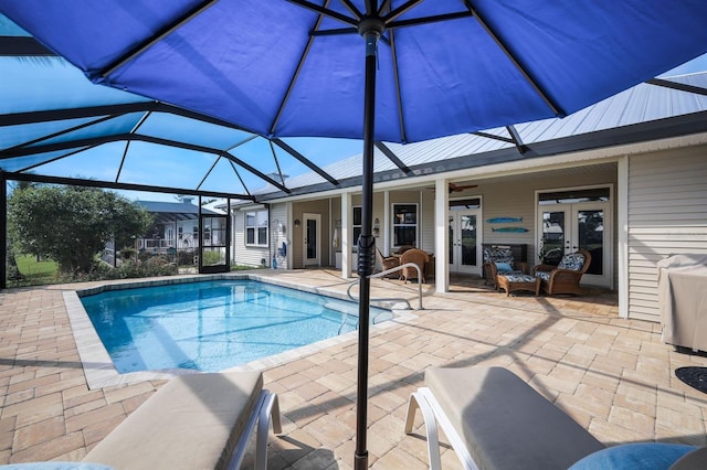 view of swimming pool with a lanai and a patio