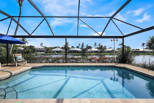 view of swimming pool with a lanai and a water view