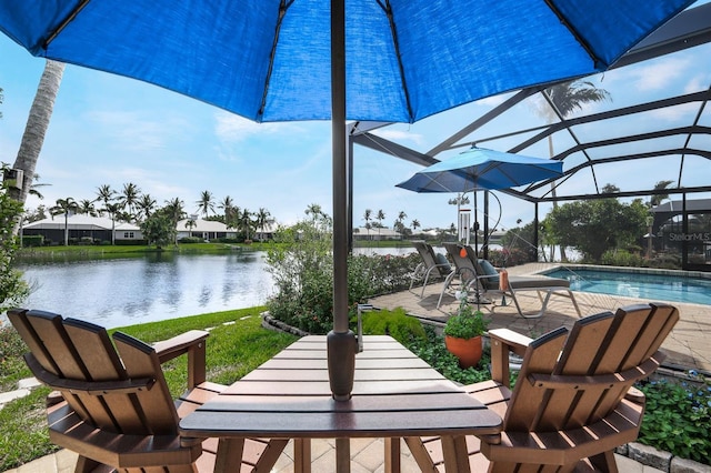 exterior space featuring glass enclosure and a water view