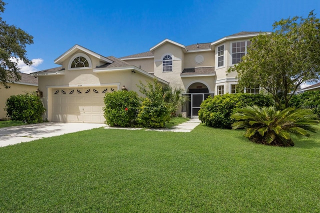 traditional-style house featuring a front yard, concrete driveway, an attached garage, and stucco siding