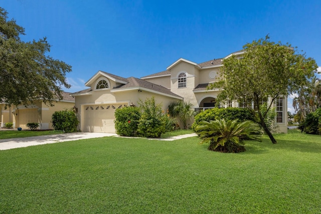 view of front of house with an attached garage, stucco siding, concrete driveway, and a front yard