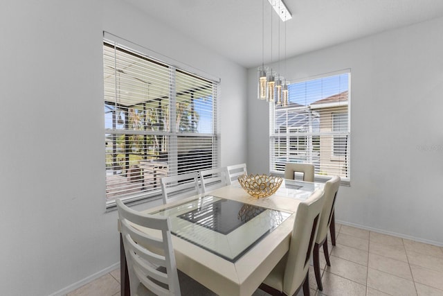 dining room featuring baseboards and light tile patterned floors