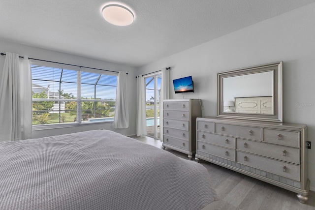 unfurnished bedroom featuring a textured ceiling and wood finished floors