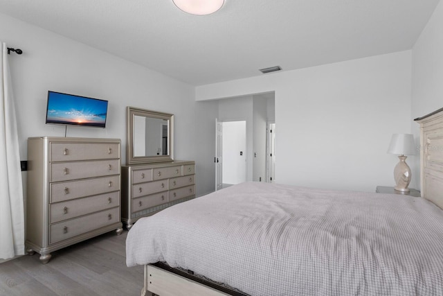 bedroom with visible vents and light wood finished floors