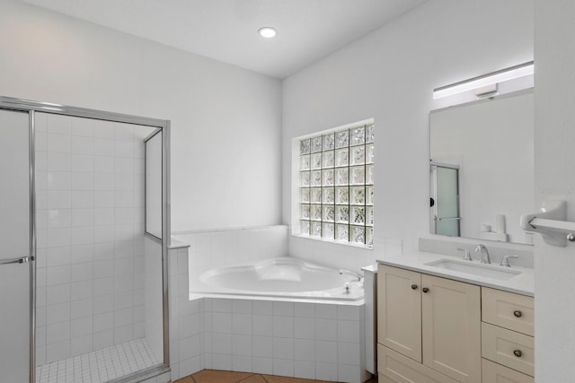 full bathroom with a bath, a stall shower, vanity, and recessed lighting