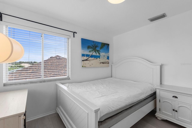 bedroom featuring dark wood-style floors, baseboards, and visible vents