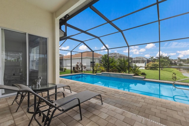 pool featuring glass enclosure, a patio, and a residential view