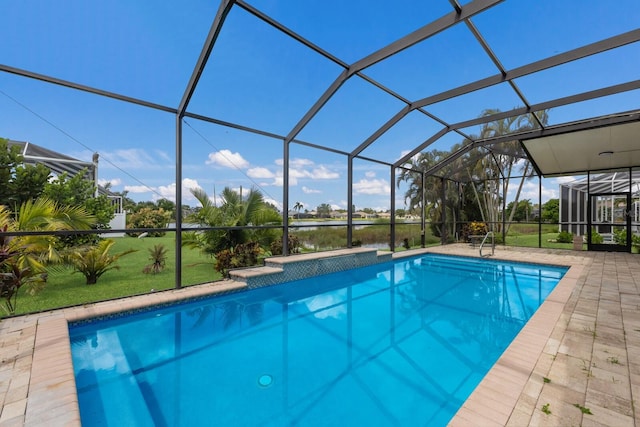 pool featuring glass enclosure, a patio, and a lawn